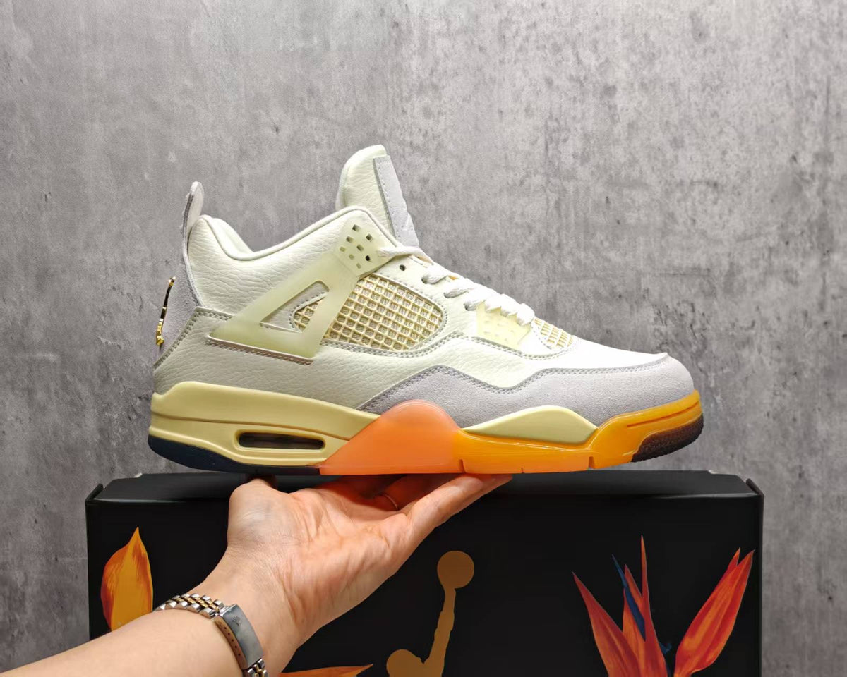 Air Jordan 4 Cream & Grey Sneakers with Orange Accents